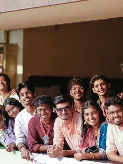 A happy group photo of college students, a perfect memory of their festival experience together.