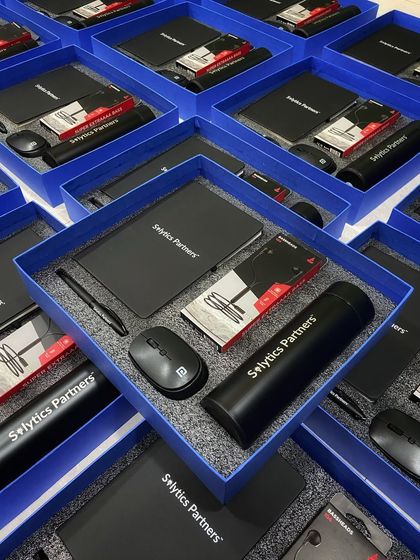 Another look at our custom welcome kits for Solytics Partners. Each item, from the notebook to the thermal flask, is branded and neatly arranged to deliver a premium and cohesive brand experience.
