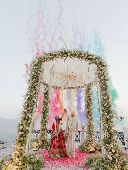 A spectacular wedding scene with the groom standing tall in our bespoke ivory sherwani. The complete look, including the coordinated safa and stole, is designed to be grand yet elegant.