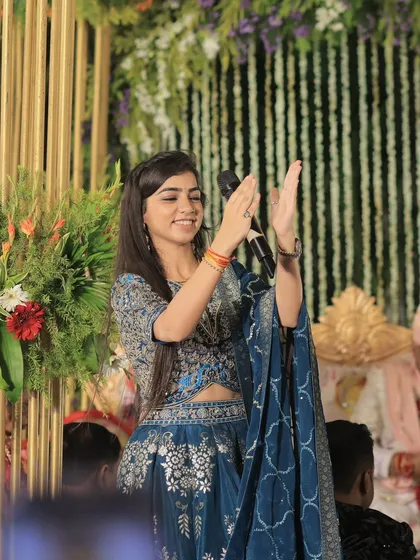 Clapping along with the crowd, feeling the energy of the music. On stage, I am completely in the moment, sharing the joy and blessings of the occasion.