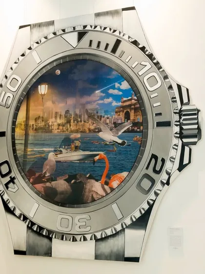 This is 'Mumbai in Motion,' a striking lenticular artwork that captures the relentless passage of time in the city that never sleeps. Framed within an iconic watch, the scene transitions from the energy of the day to the dazzling lights of the night, reflecting the city's constant evolution.