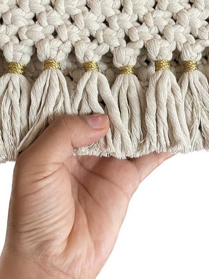 I love adding little details, like these tiny golden threads wrapped around the tassels of my off-white clutch. It just gives it a little something extra.