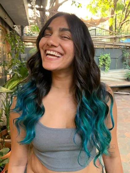 She's got the ocean tucked away in her hair. A happy client with her new teal ombre, a look that required bleach for that bright, aquatic color.