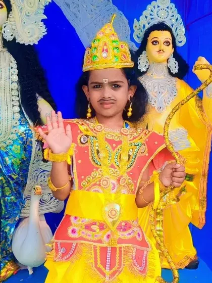 A closer look at the detailed mythological costume. You can see the ornate crown, jewelry, and the bow accessory that completes the look for a divine character performance.