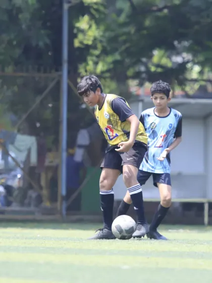 A player shields the ball from a defender, using his body effectively to protect possession. This is a fundamental skill for any midfielder or forward.