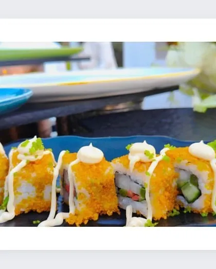 A close-up of our expertly crafted sushi rolls, topped with mayonnaise and roe, highlighting the detail in each piece.