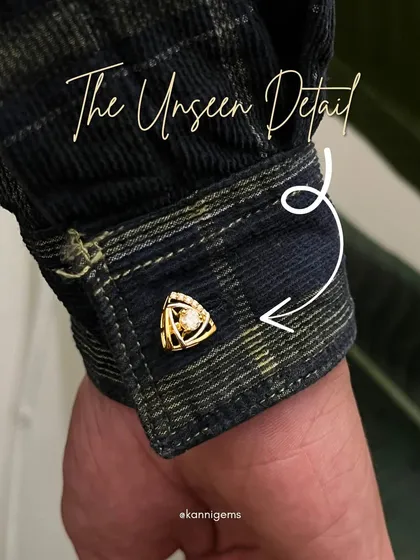 A cufflink is more than an accessory; it's a signature. This piece features a unique triangular design in polished gold, centered with a brilliant diamond, created to add a subtle yet powerful finishing touch to your cuff.