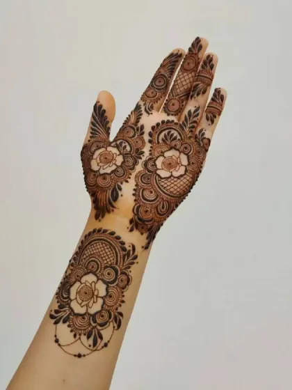 A delicate floral design on the back of the hand. This style is perfect for someone who wants a touch of henna without full coverage.