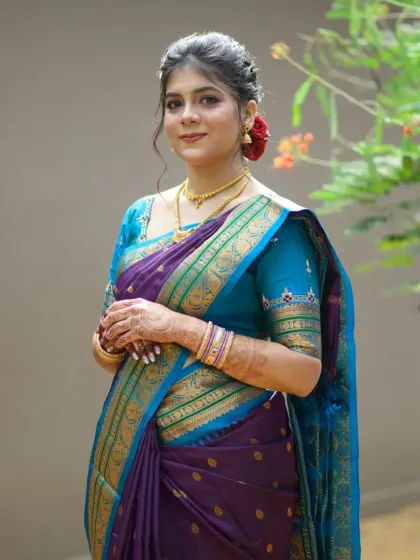 This portrait captures the bride's grace and the beautiful colour combination of her traditional Maharashtrian wedding attire.