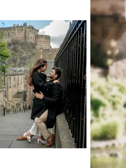 A romantic portrait with Edinburgh Castle in the background. The couple shares an intimate moment, framed by the historic architecture and greenery.