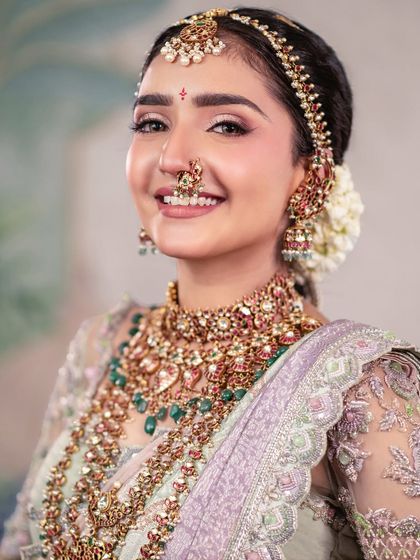 A happy bride with a beautiful smile. This portrait in a pastel saree showcases a softer, more contemporary approach to traditional bridal wear.
