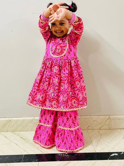 Another adorable pose from my youngest client, showing off her festive henna.