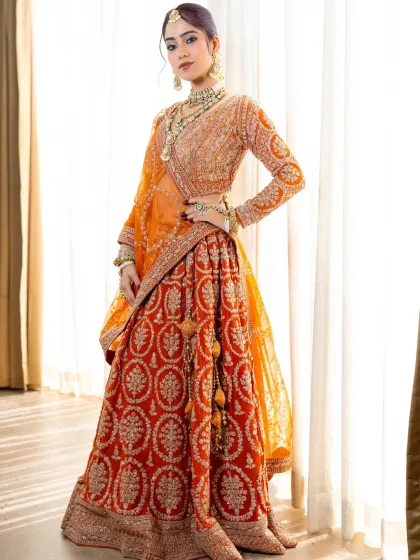 Another angle of our stunning burnt orange lehenga. The full-sleeve blouse and detailed embroidery make it a perfect choice for a winter wedding.