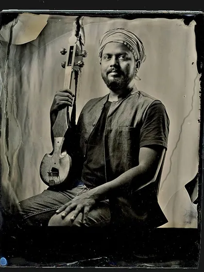 A powerful wet plate portrait of a musician holding his instrument. We have perfected this complex 19th-century technique and now offer portrait sessions for those looking for a timeless piece of art.