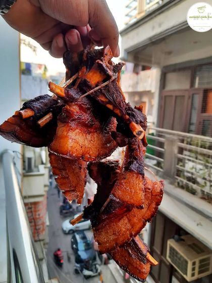 A string of perfectly fried pork ribs, crispy on the outside and juicy on the inside.