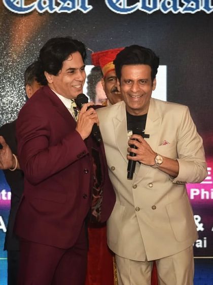 A candid moment with Manoj Bajpayee at an awards event, smiling in his custom-made blazer. My clothes are designed for real life, not just for the cameras.