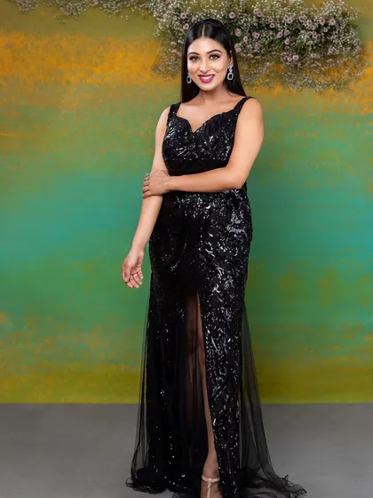 A full-length shot showing the thigh-high slit of the gown, adding to the overall glamorous and bold aesthetic of the shoot.