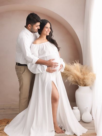 A beautiful portrait of togetherness. The way he holds her close, both of them looking towards the future, tells a story of shared love and excitement.