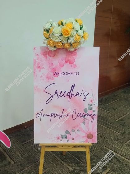 A personalized welcome sign for an Annaprasan (first rice-eating) ceremony, decorated with artificial flowers.