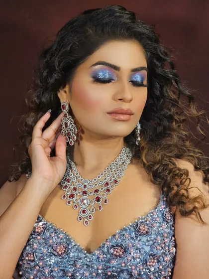 Don't be afraid to play with color. This bold, electric blue eye makeup paired with curly hair is perfect for a party or sangeet, showing that your makeup can be both artistic and beautiful.