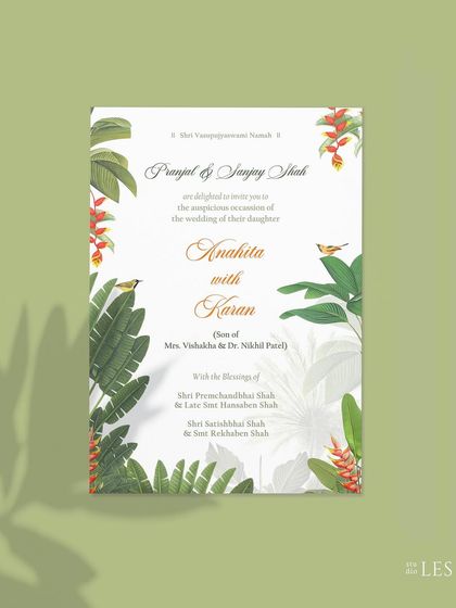 The main digital invitation card, featuring dense tropical foliage and birds. The design feels immersive and perfectly captures the feeling of a destination wedding in a lush, natural setting.