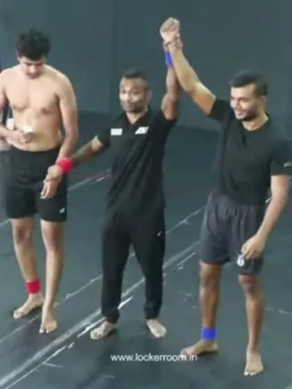 Victory declared. I am raising the hand of one of our fighters after a hard-fought win, a proud moment for both the student and the coach.
