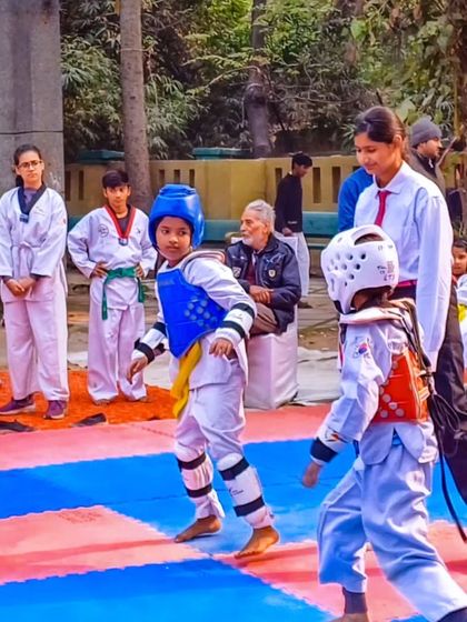 Students get ready to compete at the 2nd Delhi Open Taekwondo Championship, showing focus and readiness.