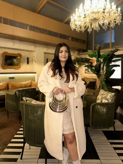 This clutch is one of my most dramatic designs, featuring a unique multi-ring gold handle. I wanted to create a piece of wearable art, a high fashion accessory that brings a touch of avant-garde glamour to an elegant evening look.