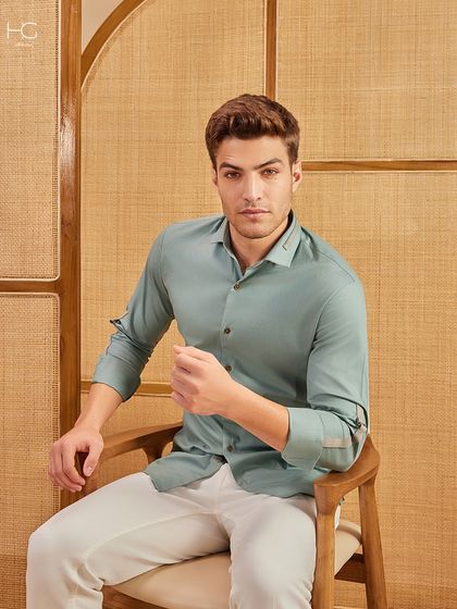 A seated view of the mint green shirt, showing off its relaxed yet tailored fit. It's a perfect example of my elevated basics for smart casual dressing.