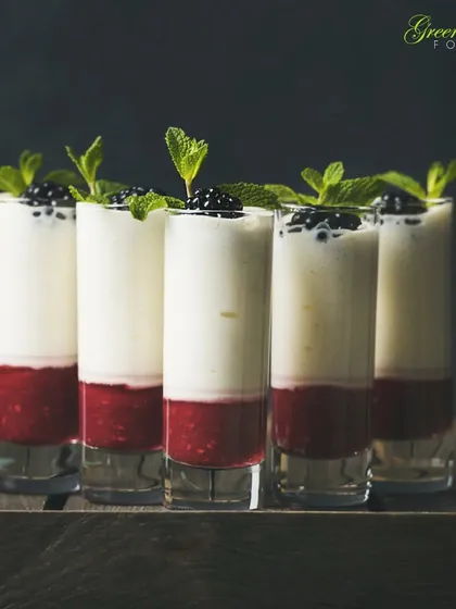 A healthy and elegant dessert or breakfast option. We layer Greek yogurt with a fresh strawberry coulis and top it with blackberries and mint, served in tall shot glasses for a modern look.