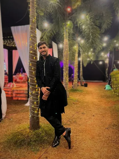 A classic black sherwani for a sangeet night. It's important to match the vibe of the event, both with the music and the style.
