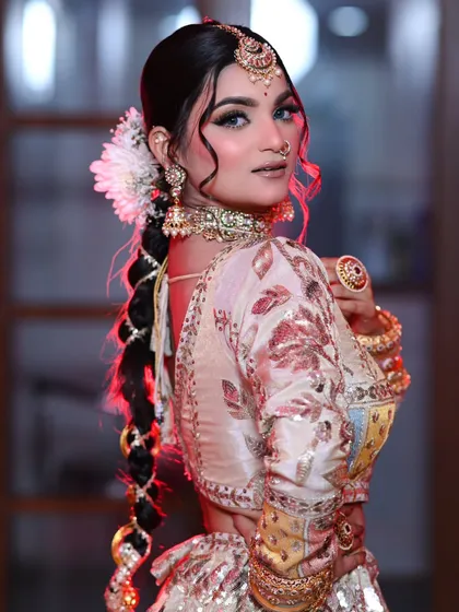 A side profile showing the beautiful braided hairstyle with a traditional parandi. A perfect fusion of modern and traditional.
