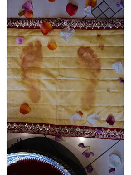 The Griha Pravesh ceremony leaves a lasting mark. Shaan's footprints, imprinted on a cloth after stepping in colored water, will be kept as a beautiful memento of her first steps into her new home.