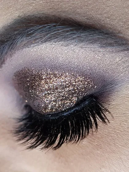 A close-up of a bronze glitter eye makeup look. This is one of the most requested styles because it's glamorous yet versatile and suits so many different Indian skin tones and outfits.