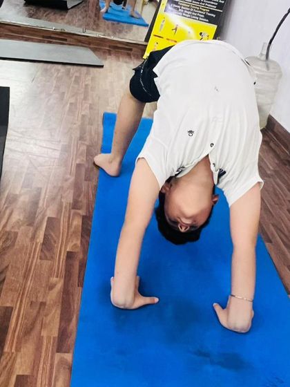 Look at that perfect Chakrasana, or wheel pose. We help kids explore their flexibility and strength safely, and they often surprise us with what they can do.