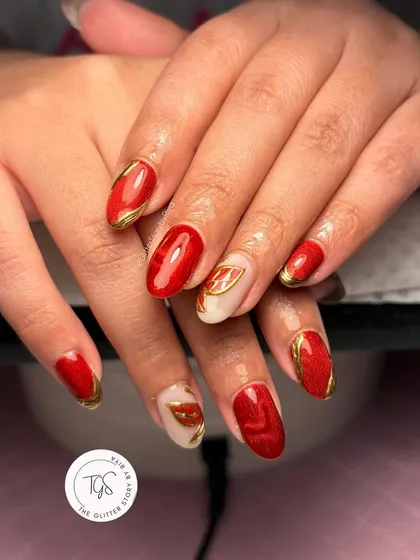 A full view of the fiery red cat-eye manicure with hand-painted gold leaf accents, a perfect choice for Diwali or Christmas.