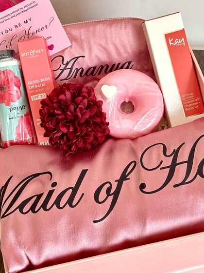 A special proposal for a special role. This 'Maid of Honor' box includes a custom robe, a personalized eye mask, premium lip care from Dot & Key and Kay Beauty, and a cute donut soap.