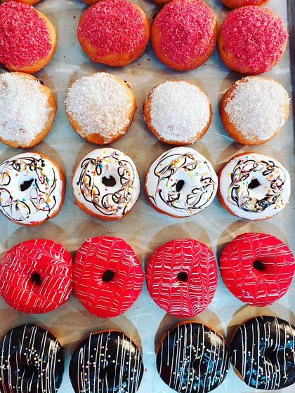 A colorful assortment of donuts from our baking diploma course, showing various glazes and sprinkles.