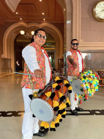 Energetic dhol players in traditional attire, ready to welcome guests with the powerful and celebratory beats of the drums.