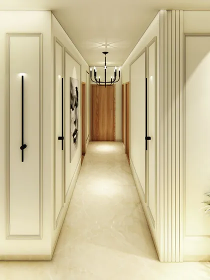 A beautifully designed hallway with classic wall molding and modern, minimalist wall sconces. The design turns a simple corridor into an elegant gallery-like space.