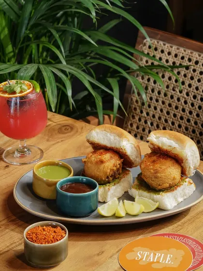 A creative twist on a classic street food. This image of tandoori vada pav is styled to look both rustic and modern, appealing to diners looking for innovative Indian flavors.