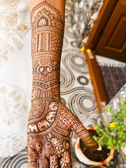 A beautiful engagement design featuring elephants and lotus flowers, extending up the arm.