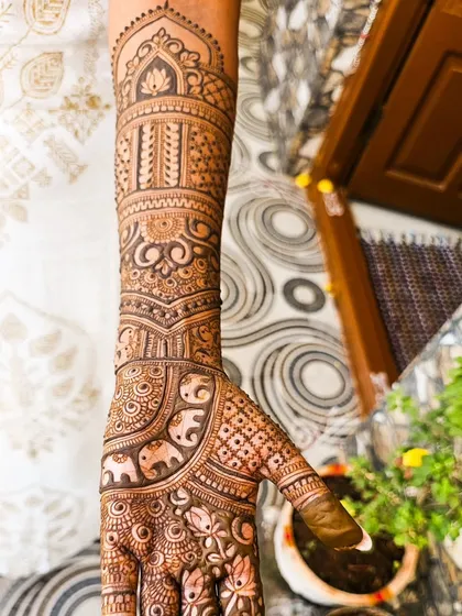 A beautiful engagement design featuring elephants and lotus flowers, extending up the arm.