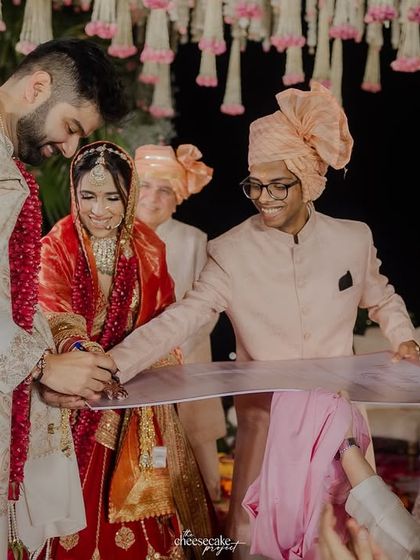 Another angle of the wedding contract signing, showing the happy involvement of their friends.