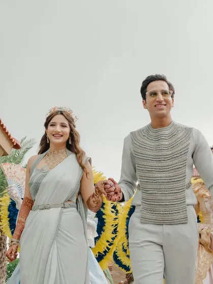 The couple making their entrance, hand in hand, looking happy and ready to celebrate.