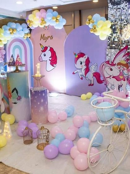 The colorful and magical unicorn-themed decor for a little girl's first birthday celebration.