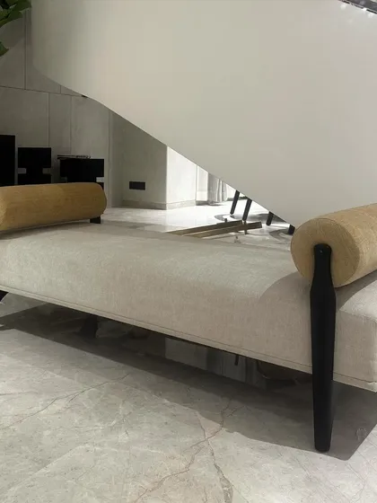 A full view of the elegant and sober day bench I customized for a project in Bangalore. The piece is upholstered in a semi-suede fabric with a solid teak base, designed to fit perfectly under a modern staircase.