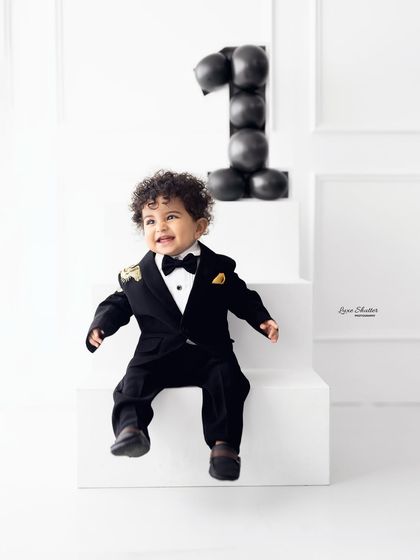 A joyful, laughing portrait of the birthday boy in his handsome suit. We capture their personality in every shot.