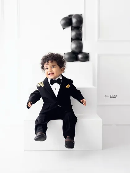 A joyful, laughing portrait of the birthday boy in his handsome suit. We capture their personality in every shot.