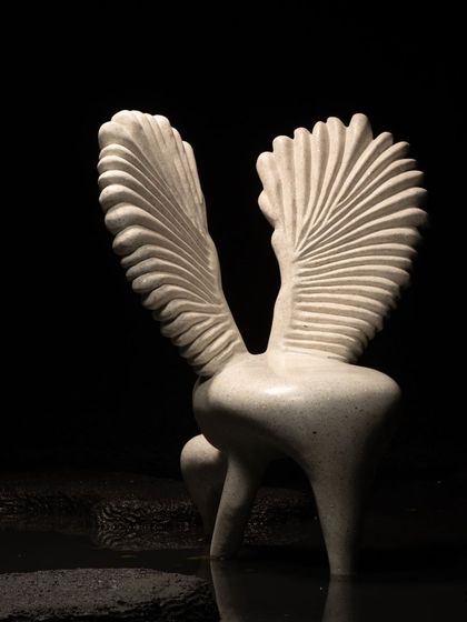 The powerful silhouette of our Pakhru chair against a dark background emphasizes its sculptural quality. It's a piece designed to be admired from every angle, a testament to our belief in creating furniture that is also a work of art.